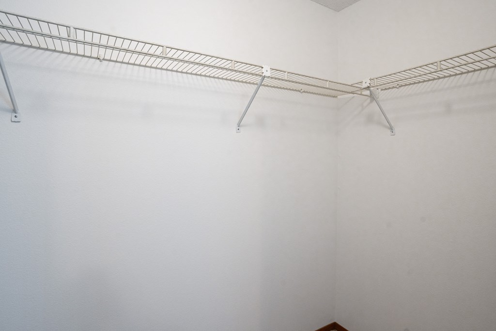 a large walk in closet with white walls. Fargo, ND Kentwood Manor Apartments