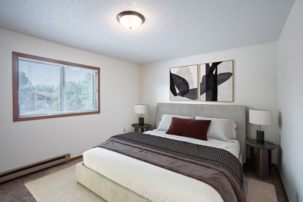 a bedroom with a large bed and a window. Fargo, ND Kentwood Manor Apartments