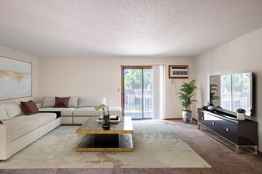 a living room with a large couch, coffee table, tv, and glass sliding door. Fargo, ND Kentwood Manor Apartments
