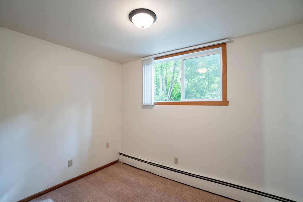 an empty room with a window and white walls. Fargo, ND Luxford Apartments