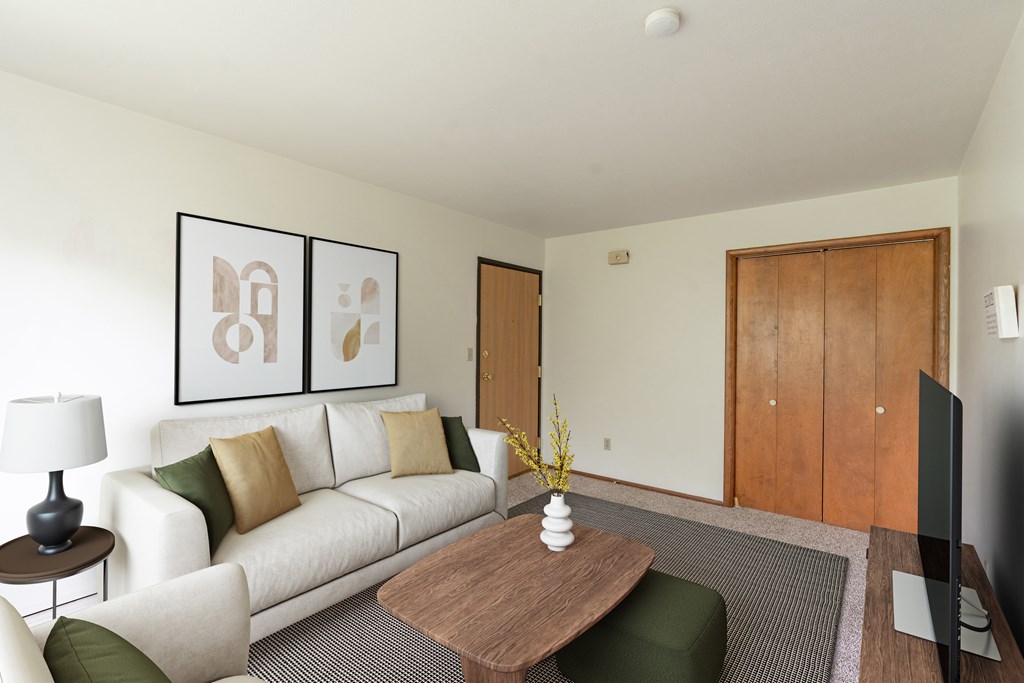 a living room with a couch and a coffee table. Fargo, ND Luxford Apartments