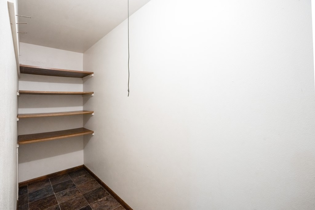 a room with white walls and shelves on the wall. Fargo, ND Martha Alice Apartments