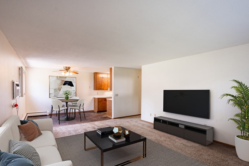 a living room with a couch and a coffee table. Fargo, ND Martha Alice Apartments
