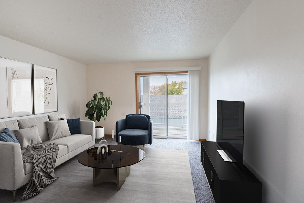 a living room with a couch and a coffee table. Fargo, ND Oxford Apartments