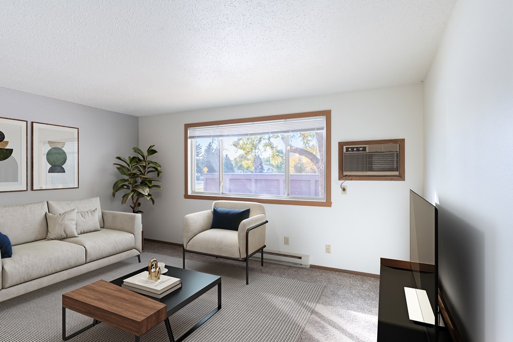 Fargo, ND Pacific Park Apartments | 21B | Living a living room with a couch and a table and a window. Fargo, ND Pacific Park Apartments