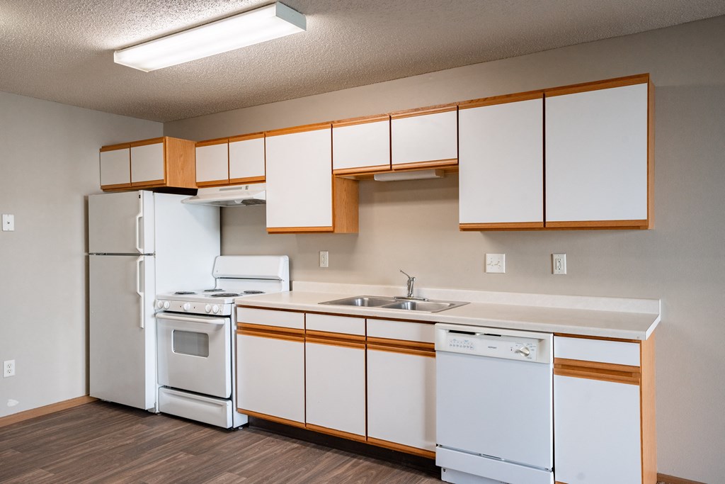 a kitchen with white appliances and white cabinets and a white refrigerator