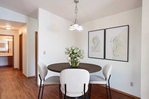 a dining room with a table and chairs. Fargo, ND Rosegate Apartments