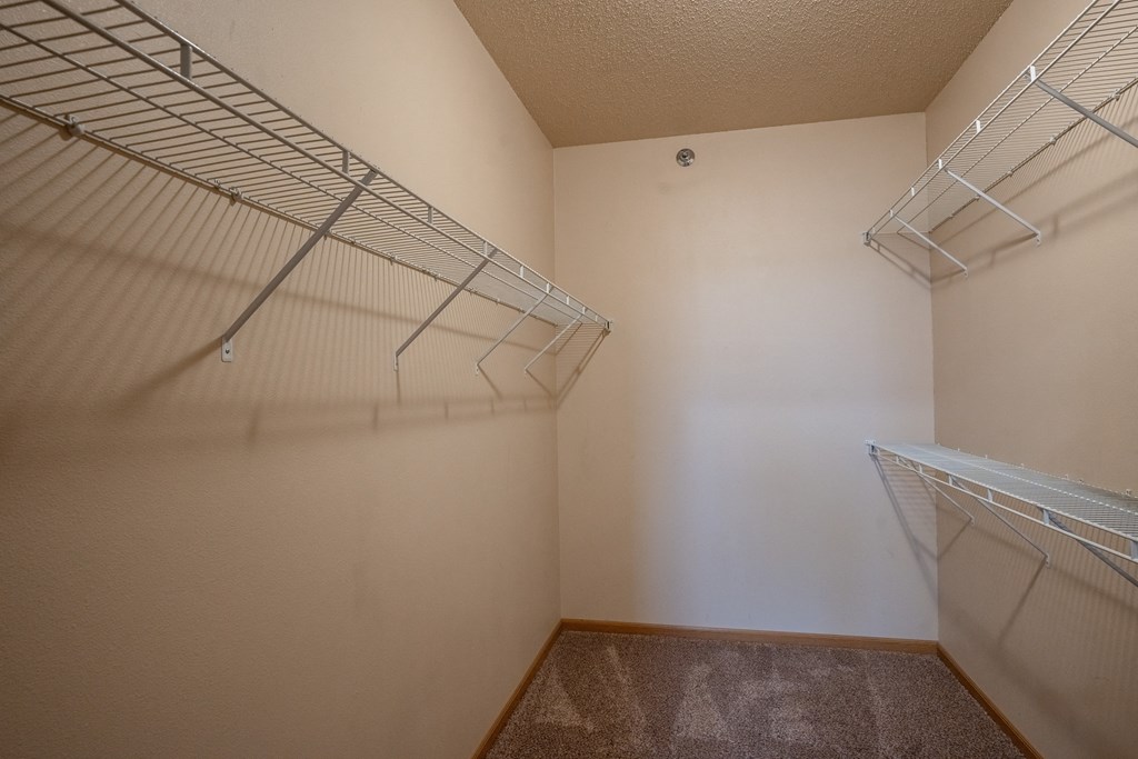 the spacious closet in the bedroom of an apartment with two closets. Fargo, ND West Lake Apartments