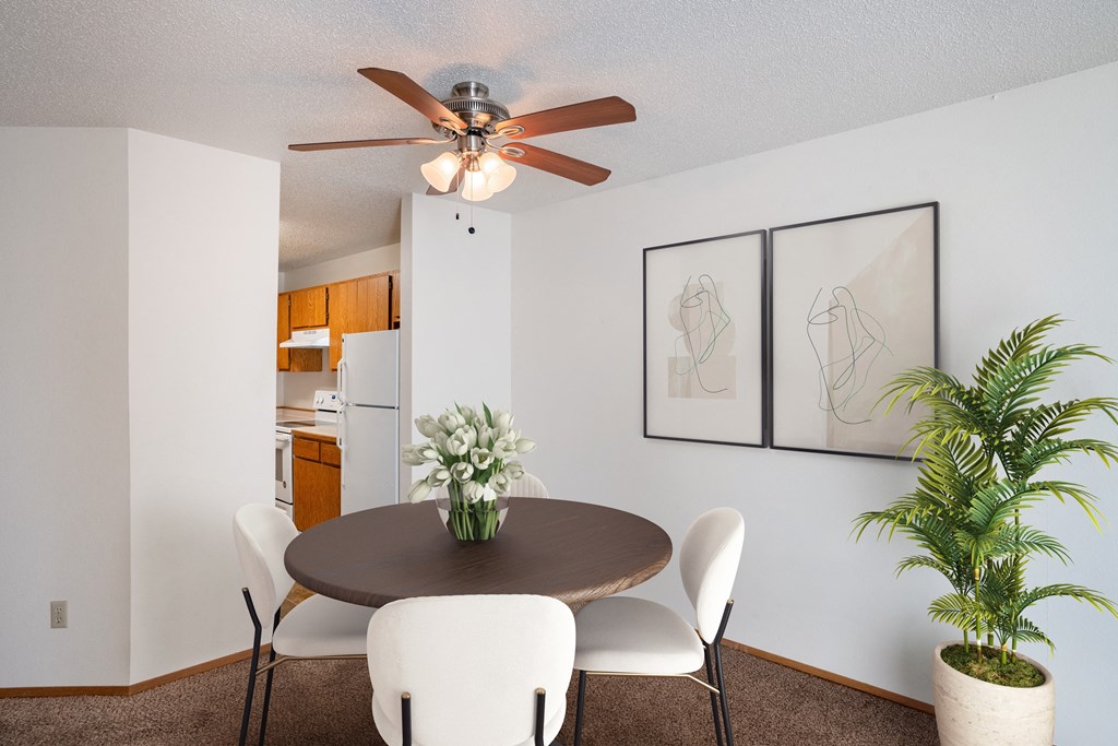 Fargo, ND Westview Towers Apartments | Dining a dining room with a table and chairs and a ceiling fan. Fargo, ND Westview Towers Apartments
