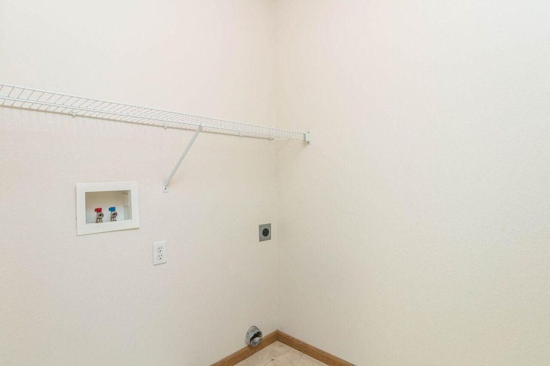 a white bathroom with a shelf on the wall. Fargo, ND Foxtail Townhomes