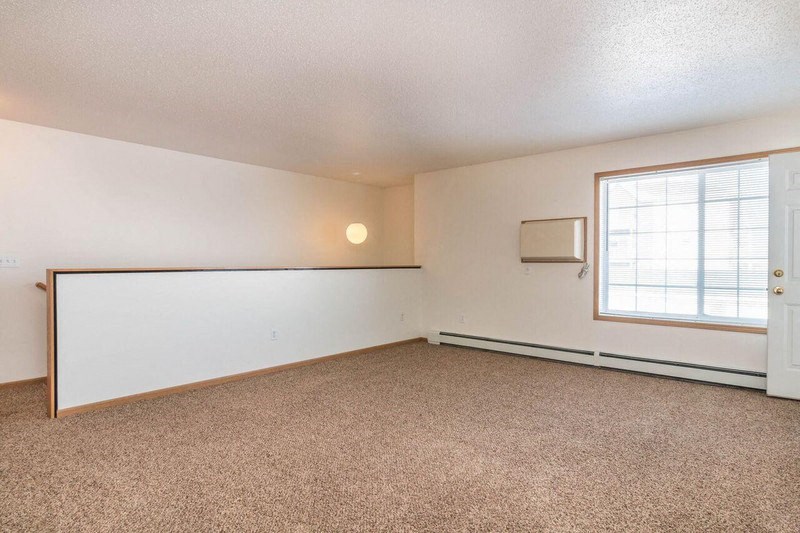 an living room with a window and a white wall. Fargo, ND Foxtail Townhomes