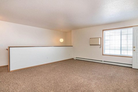 Fargo, ND Foxtail Townhomes | Living an living room with a window and a white wall. Fargo, ND Foxtail Townhomes