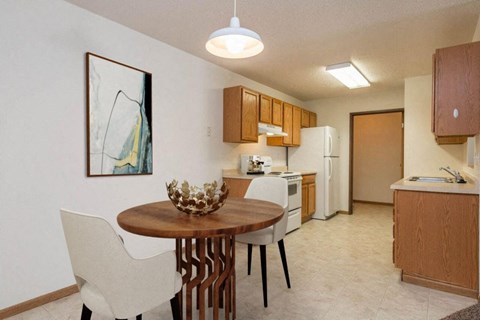 a kitchen and dining room with a table and chairs
