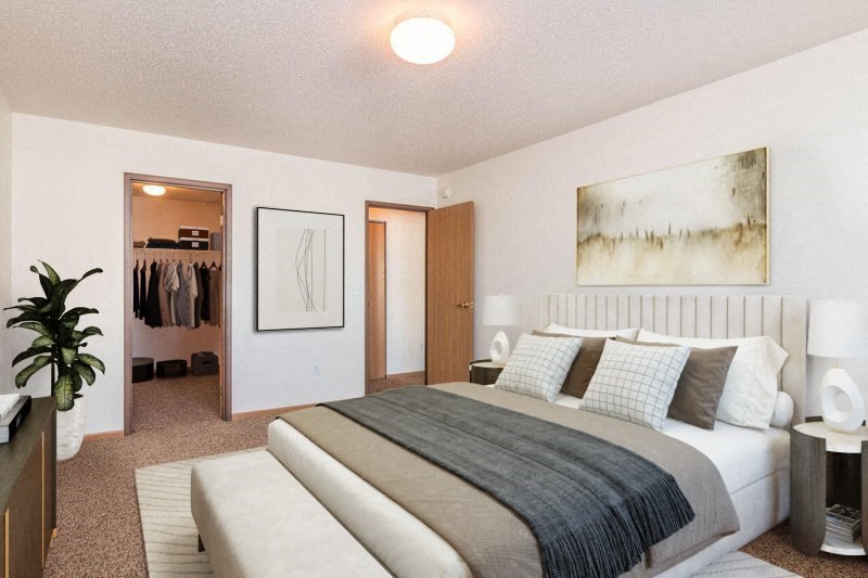 a bedroom with a bed and a closet. Fargo, ND Foxtail Creek Townhomes