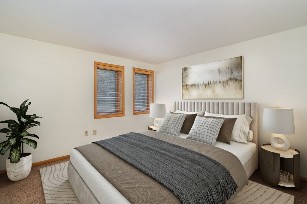 Golden Valley, MN Valley View Apartments | 11B | Bedroom a bedroom with a bed, night stands, and two small windows. Golden Valley, MN Valley View Apartments | 11B | Bedroom