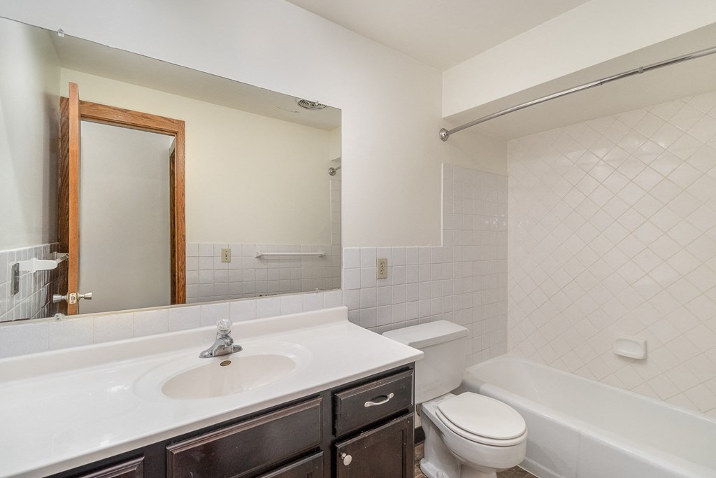 a bathroom with a bathtub, toilet, and sink.  Golden Valley, MN Valley View Apartments.