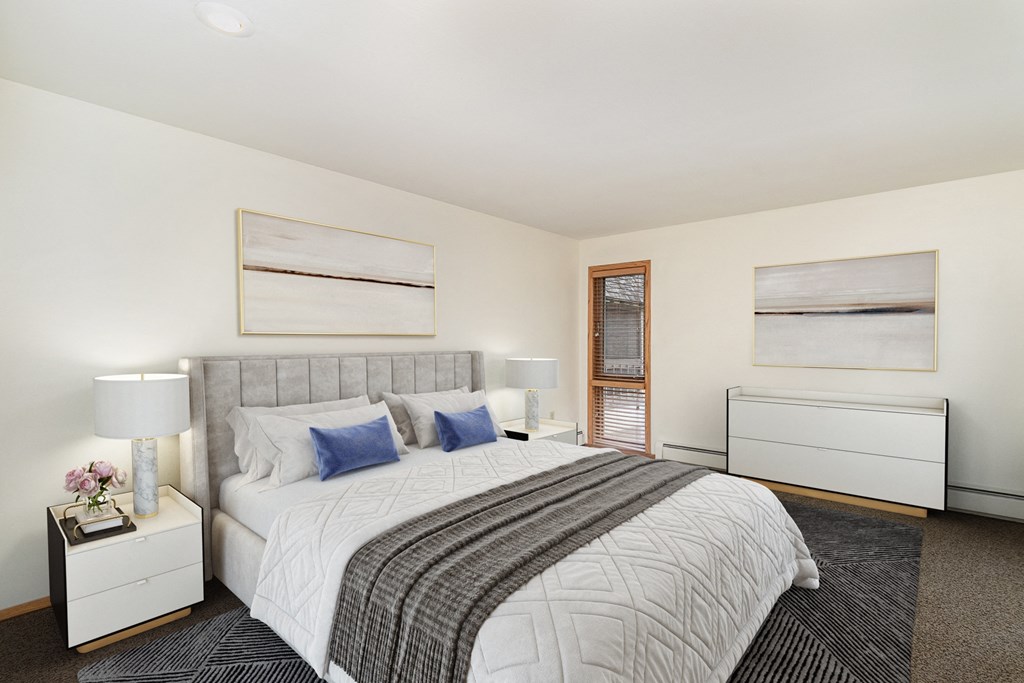 a bedroom with a large bed and two windows. Golden Valley, MN Valley View Apartments