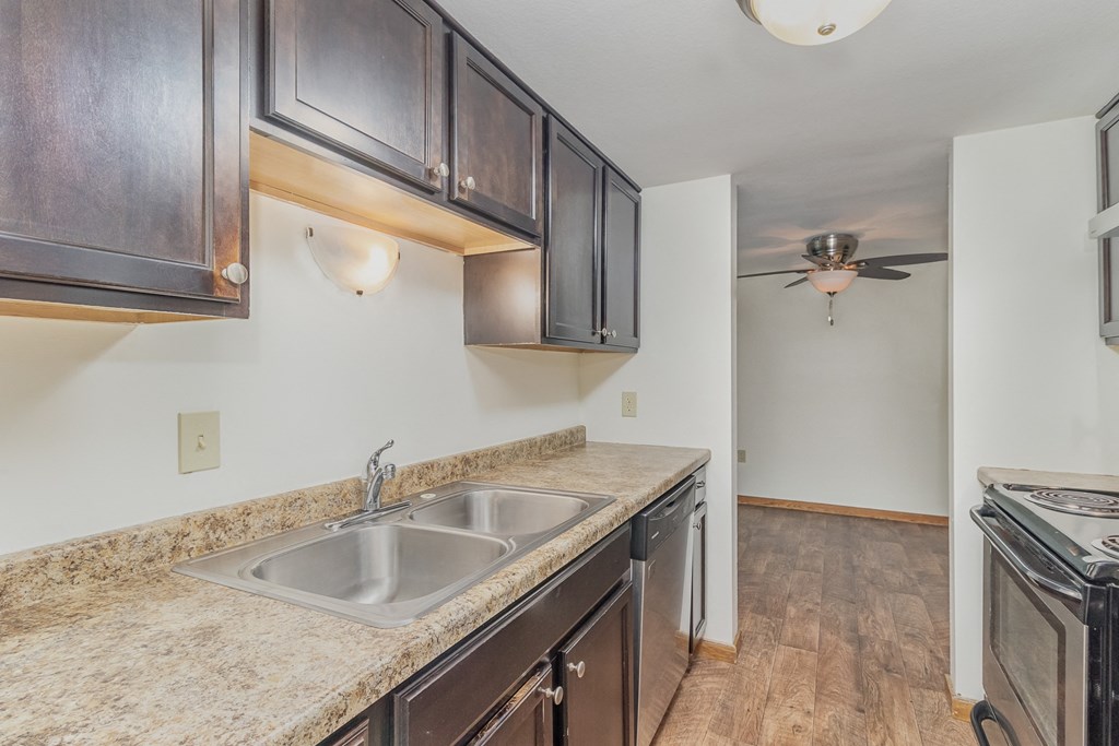 an empty kitchen with a sink and a ceiling fan.  Golden Valley, MN Valley View Apartments