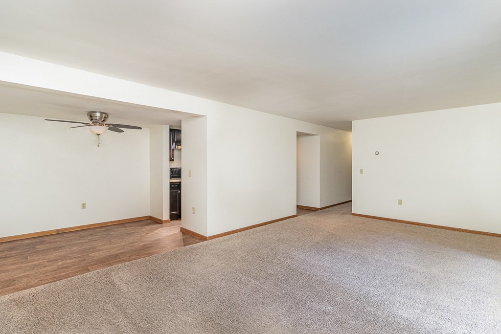an empty living room with white walls and a ceiling fan.  Golden Valley, MN Valley View Apartments