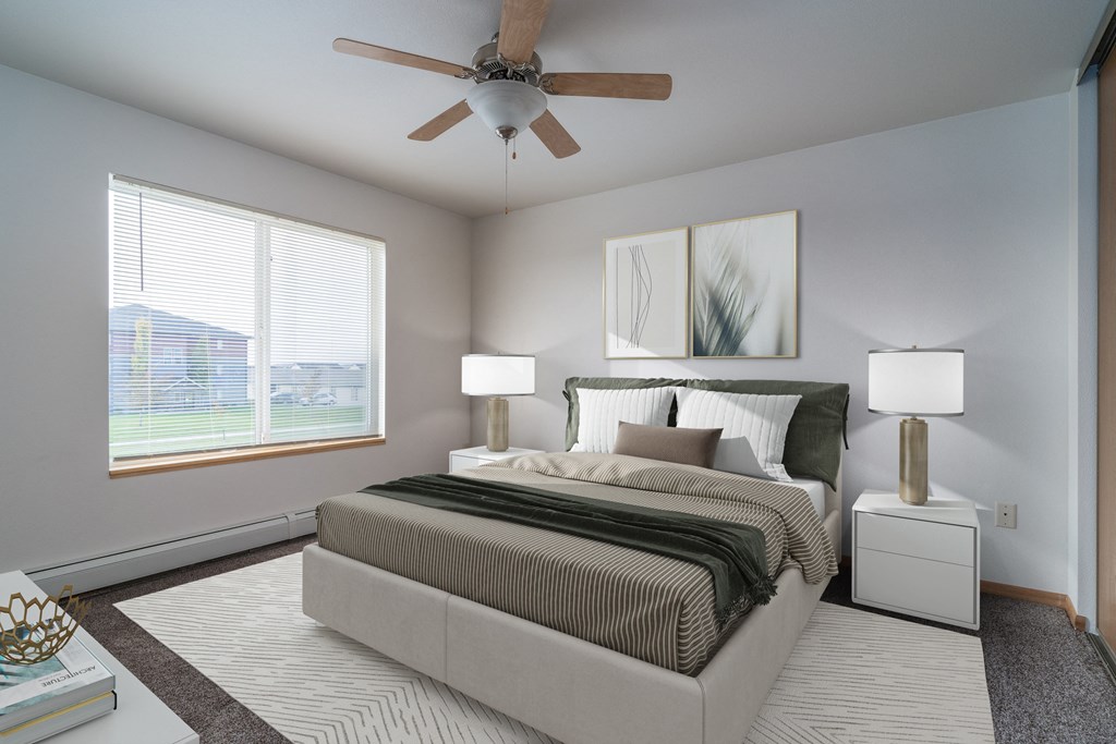 Grand Forks Desoto Estates | Bedroom a spacious bedroom with a ceiling fan and a bed. Grand Forks Desoto Estates