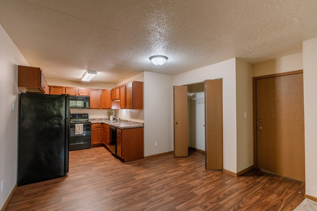 Grand Forks, ND Autumn Apartments. The entry to an apartment unit with a dining room, kitchen, and closet.