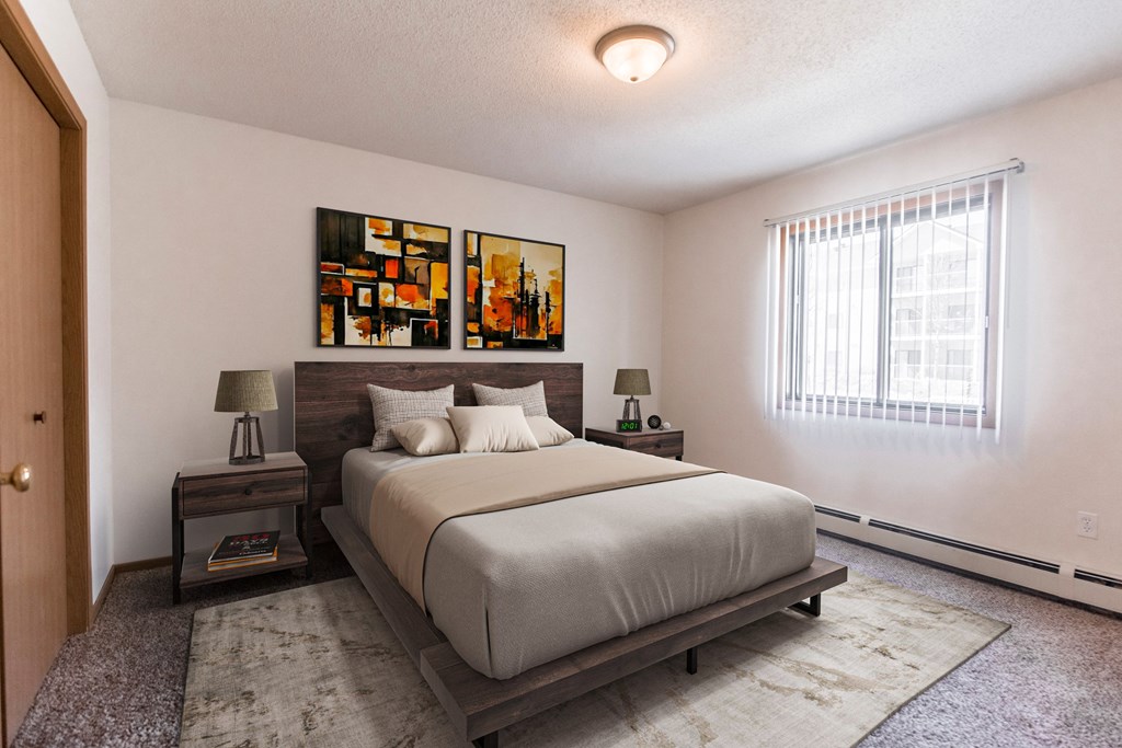 Grand Forks, ND Autumn Ridge. A bedroom with a bed and two nightstands with a window.