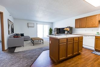 Grand Forks, ND Autumn Ridge. a kitchen and living room with a couch and coffee table - Photo Gallery 3