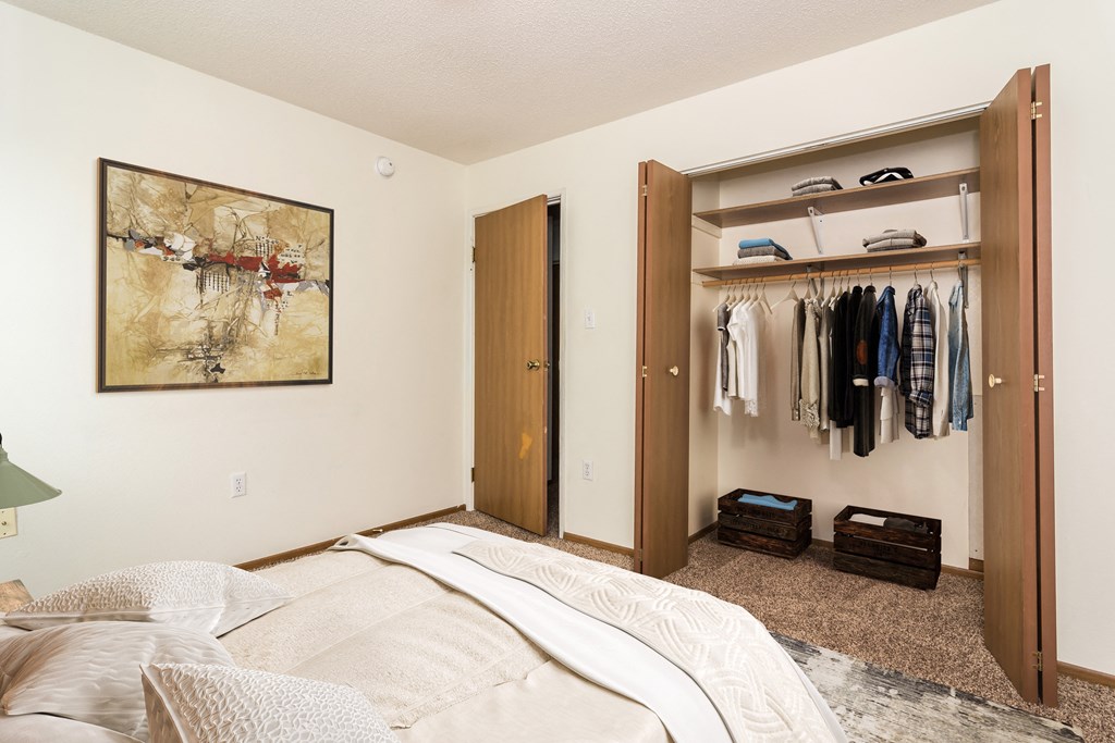Grand Forks, ND Bristol Park Apartments. a bedroom with a closet and a painting on the wall