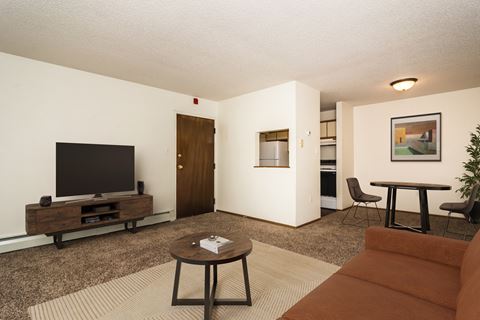 Grand Forks, ND Bristol Park Apartments. a living room with a couch a table and a television