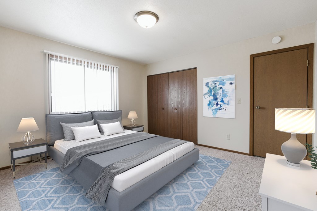 Grand Forks, ND Carling Manor Apartments.  a bedroom with a bed and two nightstands
