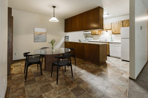 a kitchen and dining room with a table and chairs