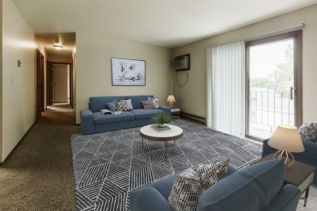 Grand Forks, ND Carling Manor Apartments.  a living room with two couches and a coffee table in front of a sliding glass door