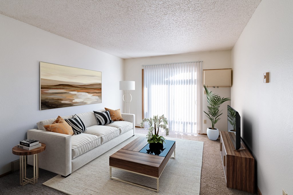 a living room with a couch and a coffee table. Grand Forks, ND Chandler 1866 Apartments