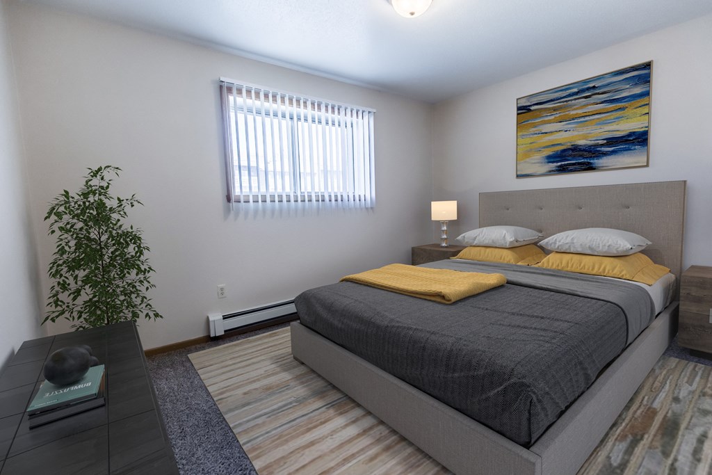 Grand Forks, ND Cherry Creek Apartments. A bedroom with a bed, window, and a nightstand