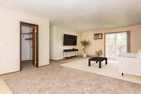 Grand Forks, ND Grandview I Apartments. a living room with a white couch and a black coffee table