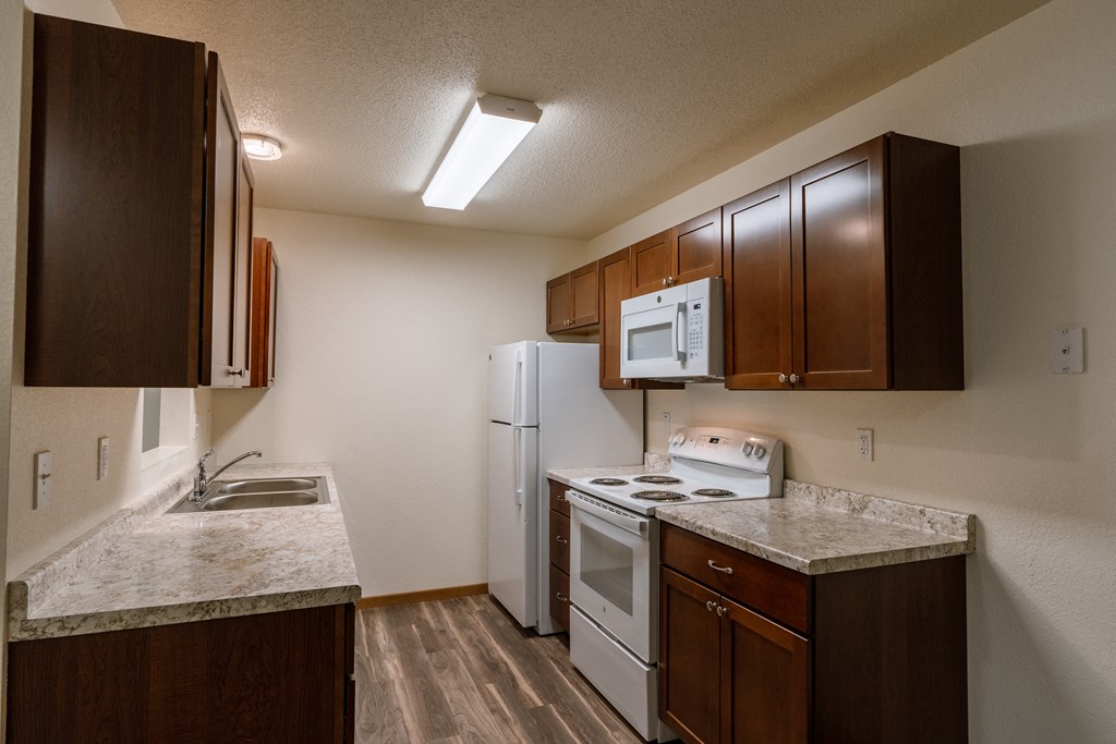 Grand Forks, ND Grandview Apartments. A kitchen with white appliances.