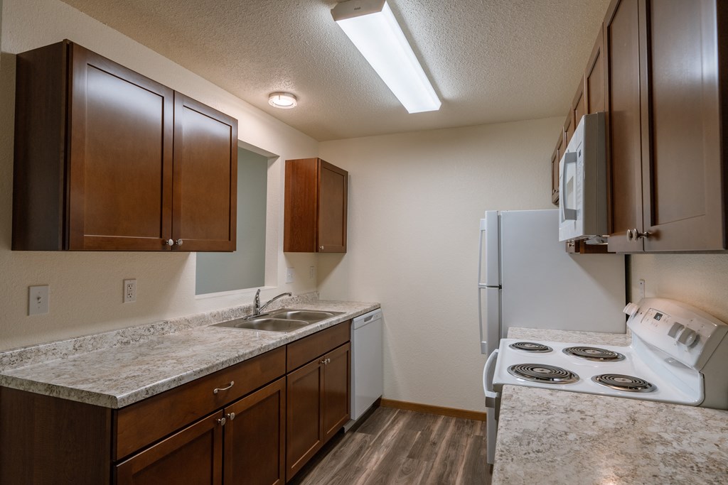 Grand Forks, ND Grandview Apartments. A kitchen with white appliances.