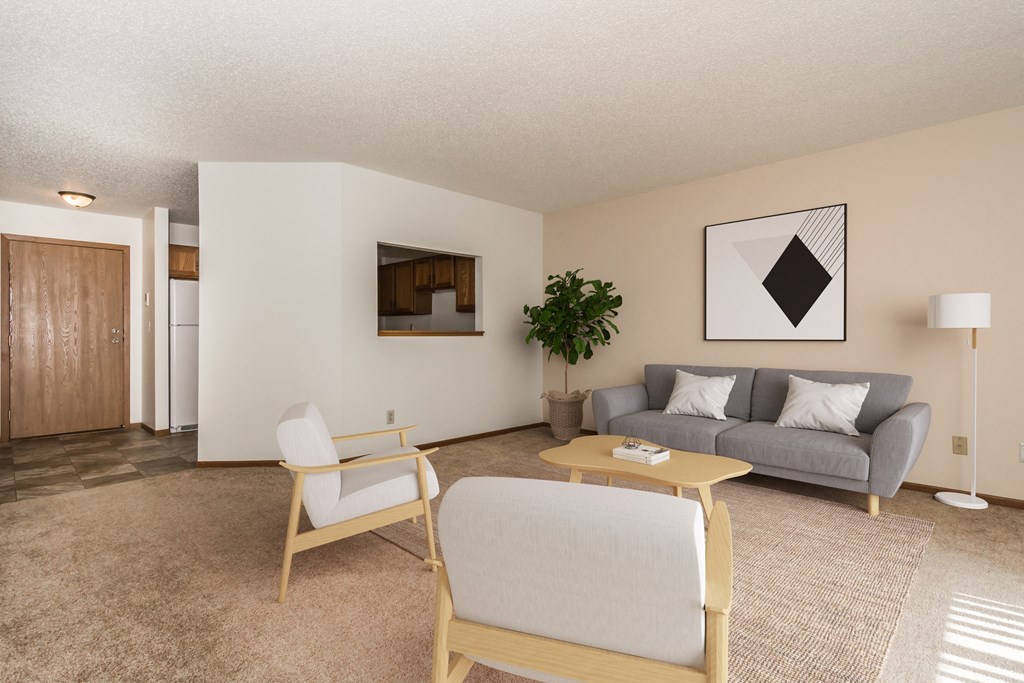 Grand Forks Harrison and Richfield Apartments. A living room with a couch chairs and a coffee table