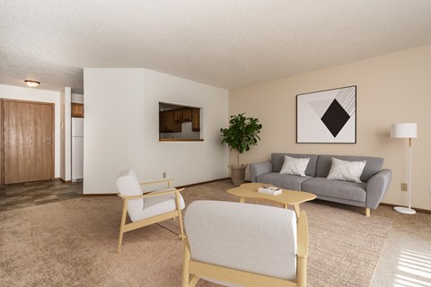 A living room with a couch chairs and a coffee table  at Harrison and Richfield, Grand Forks, North Dakota
