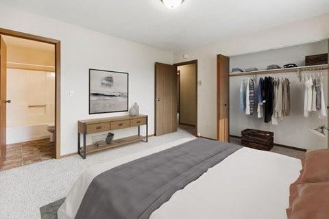 A bedroom with a large bed and a closet  at Harrison and Richfield, Grand Forks
