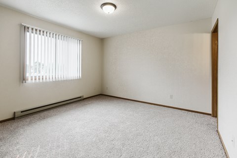 Grand Forks Harrison Apartments. A bedroom with a window and closet.