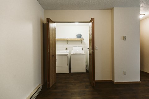 Grand Forks Harrison Apartments. A dining room with a door open to a kitchen and laundry room