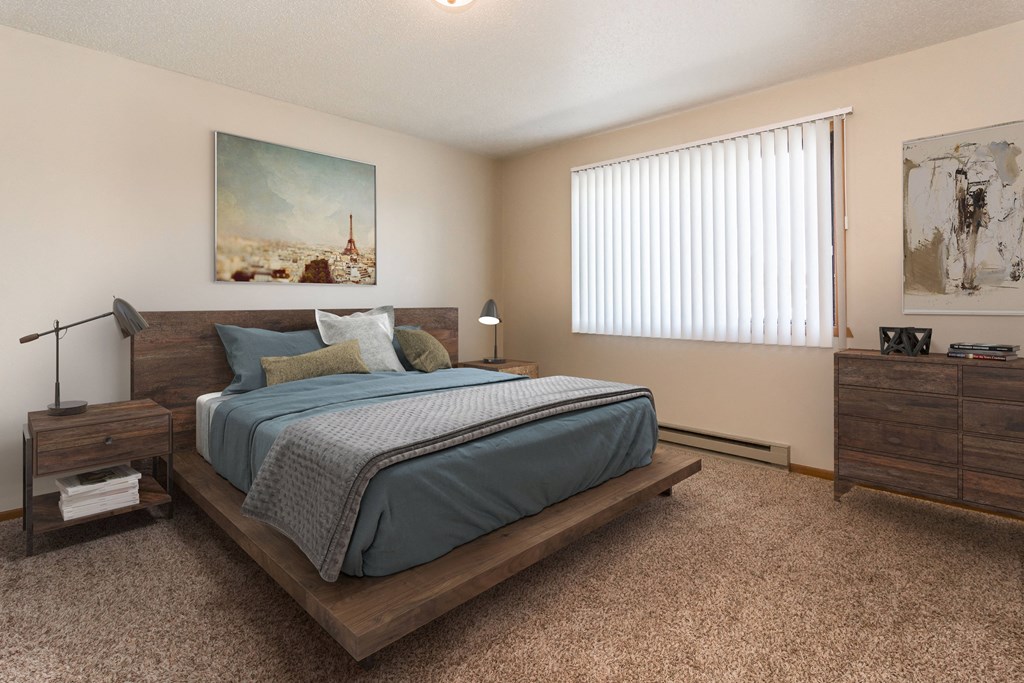Grand Forks Kremer Apartments. A bedroom with a large window, a bed, and night stands