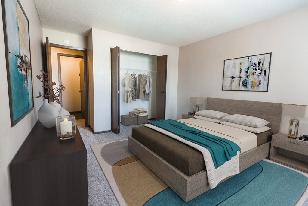 Grand Forks, ND Library Lane Apartments. a bedroom with a bed, dresser, and a closet