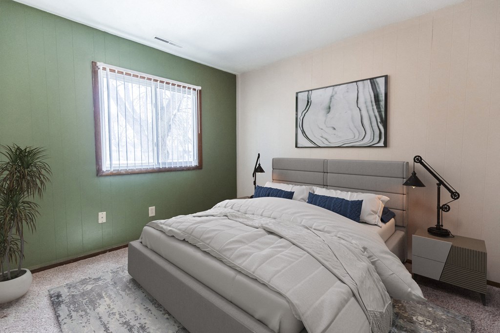 Grand Forks, ND Louise Apartments. A bedroom with a bed and a window