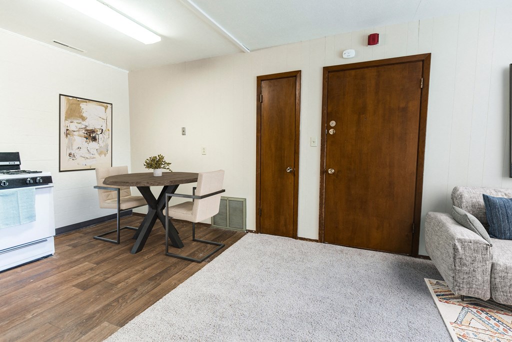 Grand Forks, ND Louise Apartments. a dining room with a table with 2 chairs.