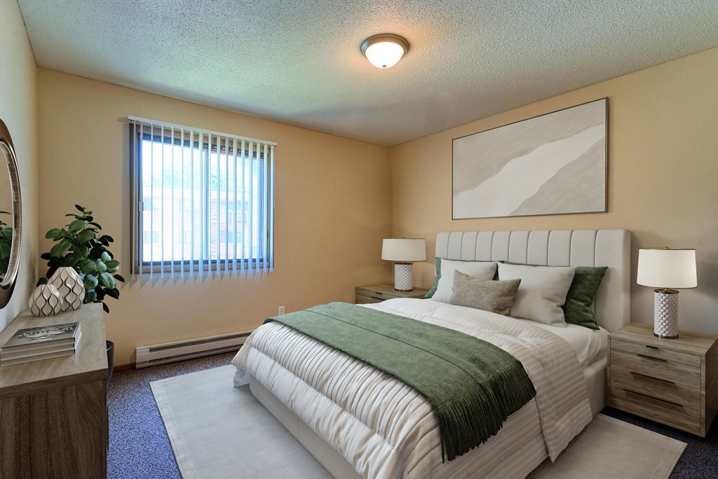 Grand Forks, ND Madison Apartments | Bedroom a bedroom with bed, dresser, and a window. Grand Forks, ND Madison Apartments