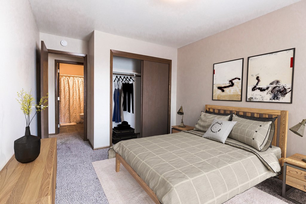 Grand Forks, ND Mayfair Apartments. a bedroom with a bed and a dresser in a room