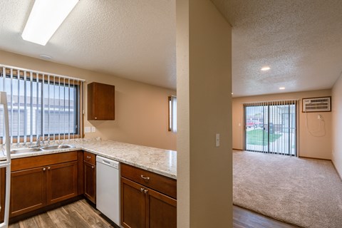 Grand Forks, ND Richfield Apartments. A view of the kitchen and living room from the counter top in an empty house