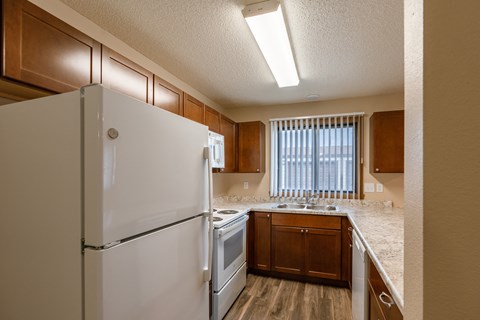 Grand Forks, ND Richfield Apartments. A kitchen with white appliances and a window.